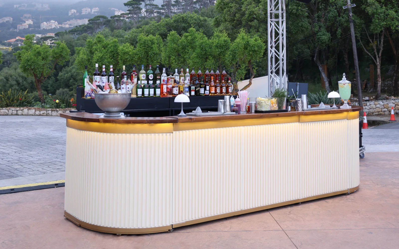 The Cream Bar by Malabar: a fluted cream counter with a warm timber top, lit from within at dusk