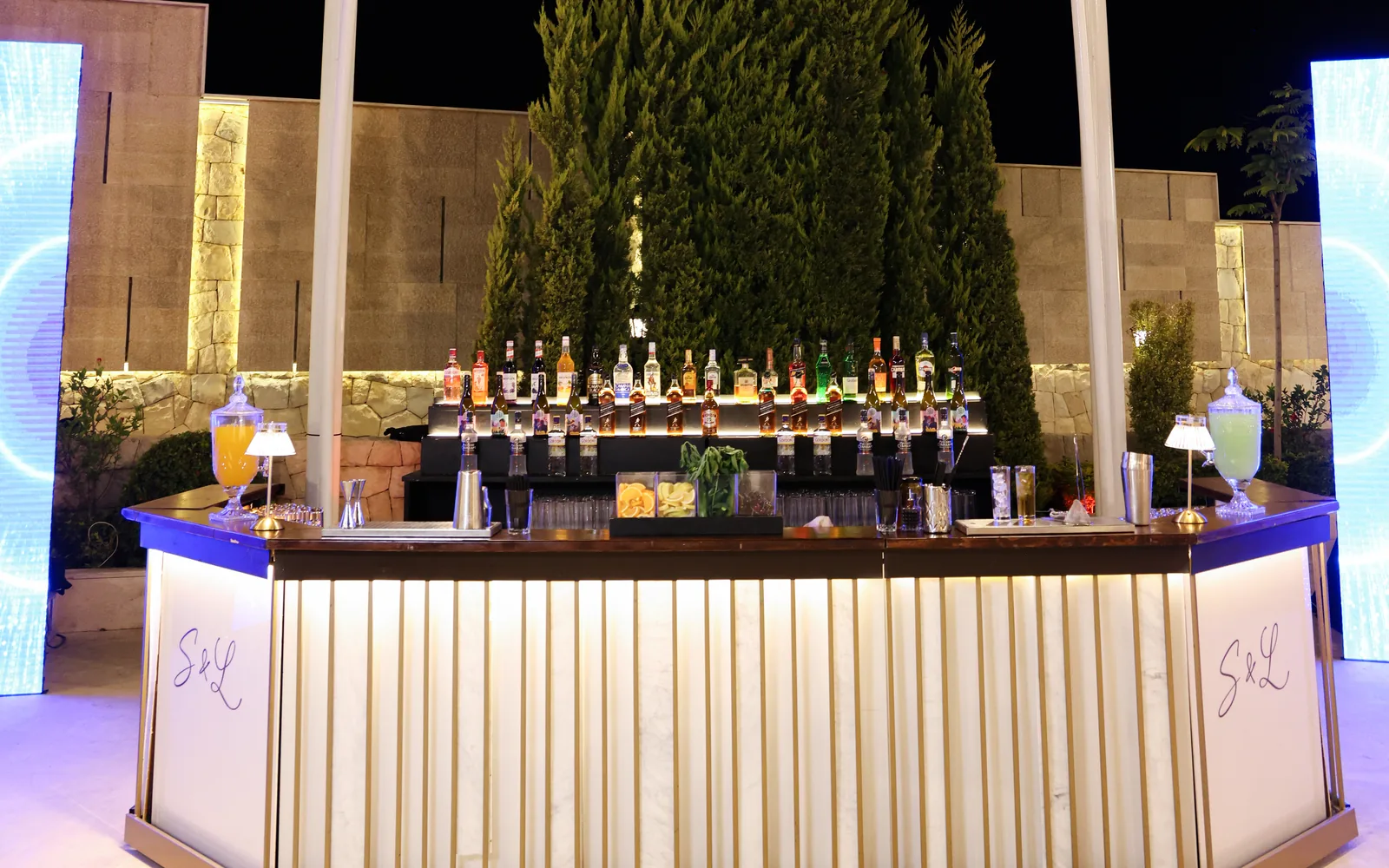 The Pannel Bar by Malabar: illuminated fluted panels lit from within at an evening reception