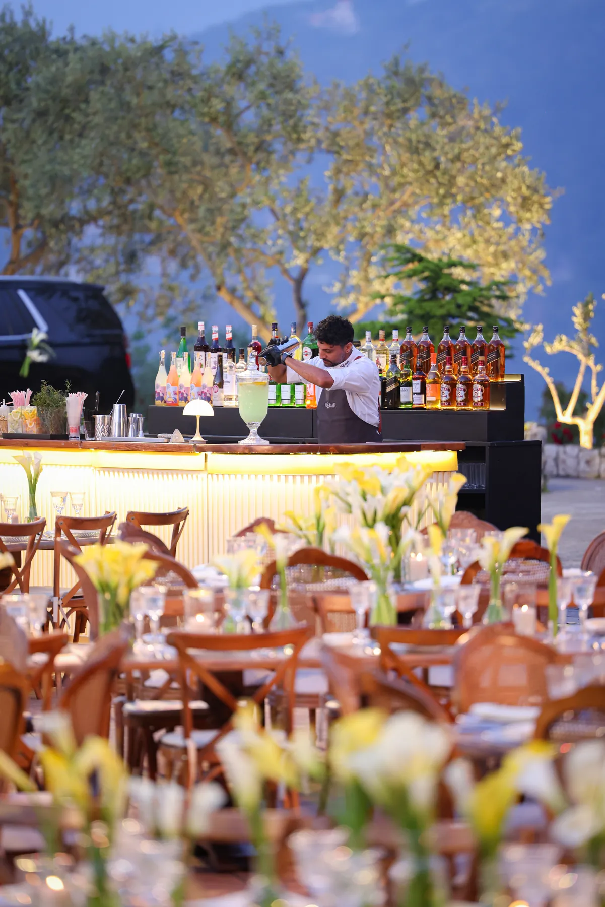 The Cream Bar overlooking a reception with dining tables and a mountain view