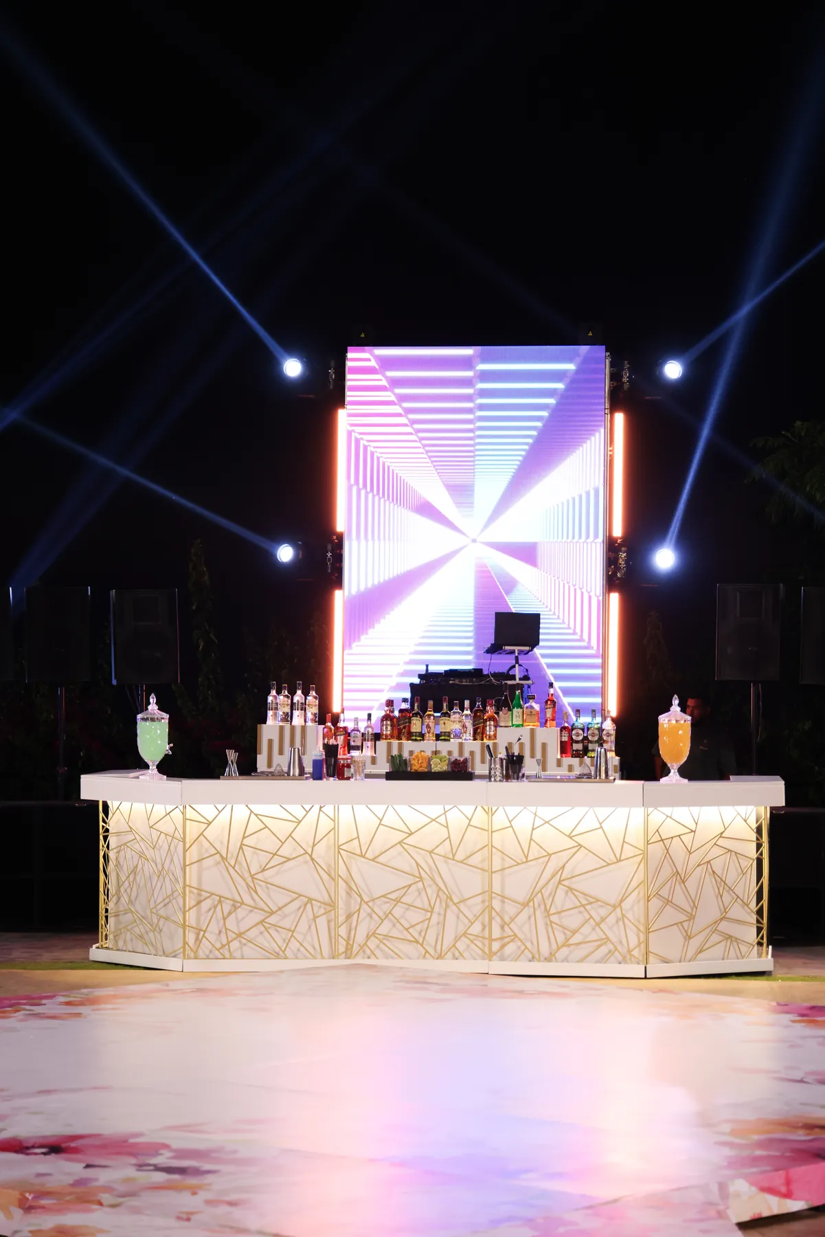 The Geometric Bar beneath event lighting with a geometric LED screen behind it