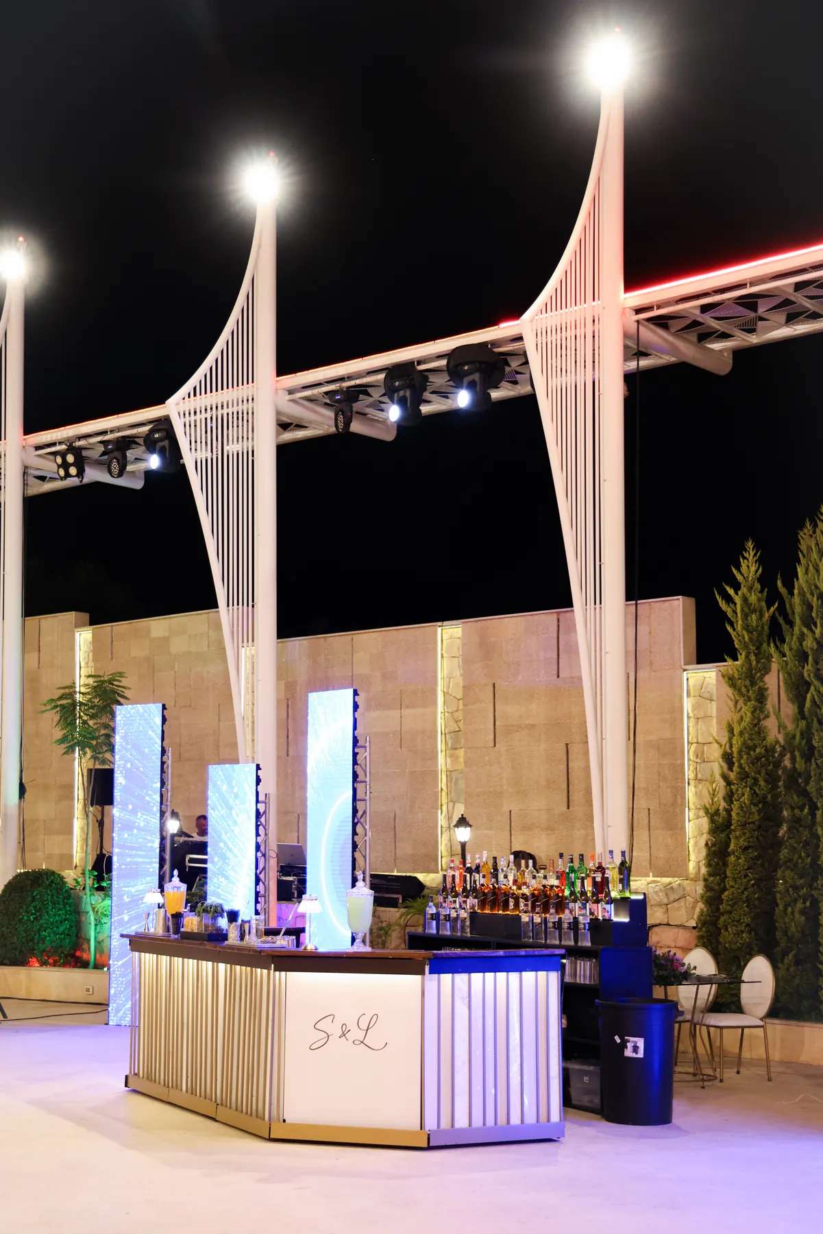 Side view of the personalised Pannel Bar beneath sculptural event lighting