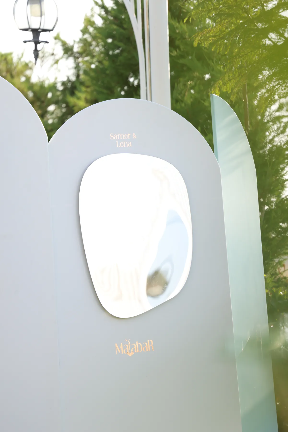 Curved mirror and sage panel detail on the Ambiance welcome station