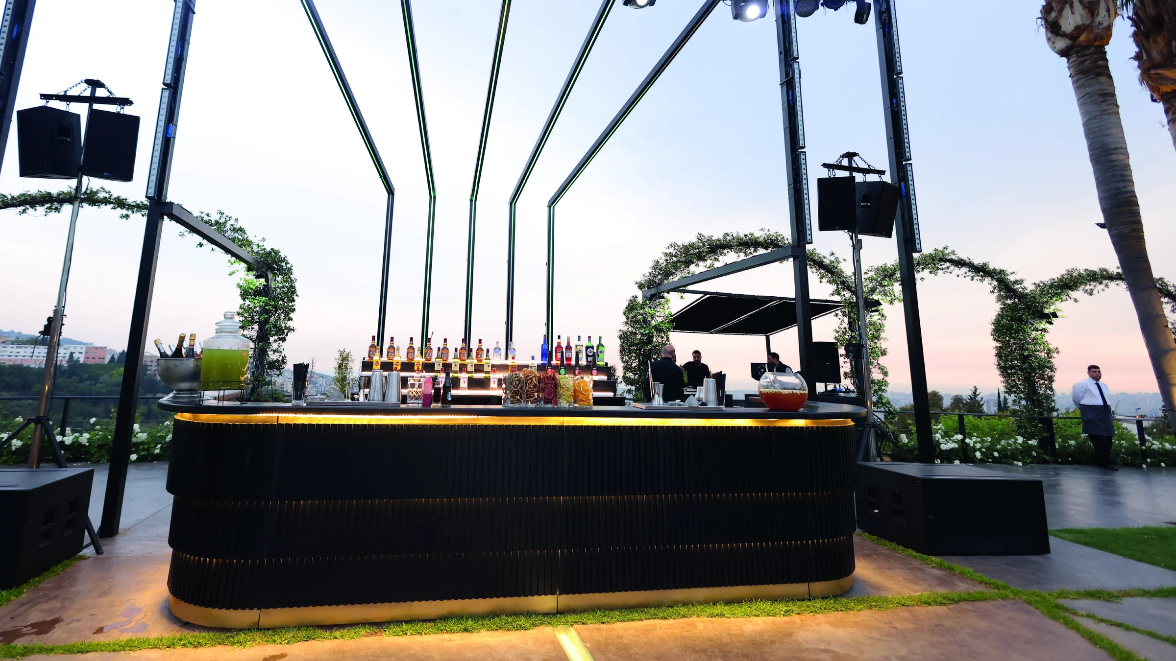 The Luxury Bar by Malabar: a dark sculptural counter on a terrace at sunset